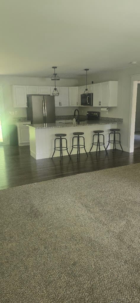 Open-concept kitchen and living area, tidy and spotless after a cleaning visit